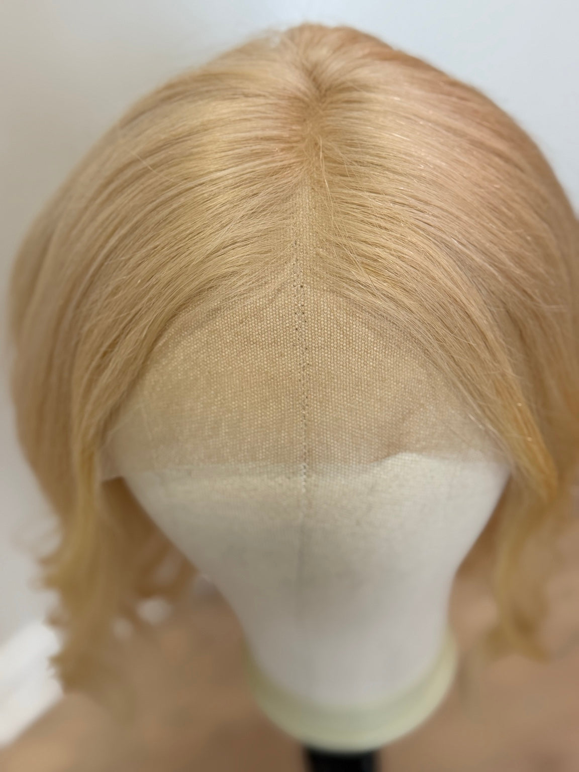 Monica platinum blonde part and hairline close-up