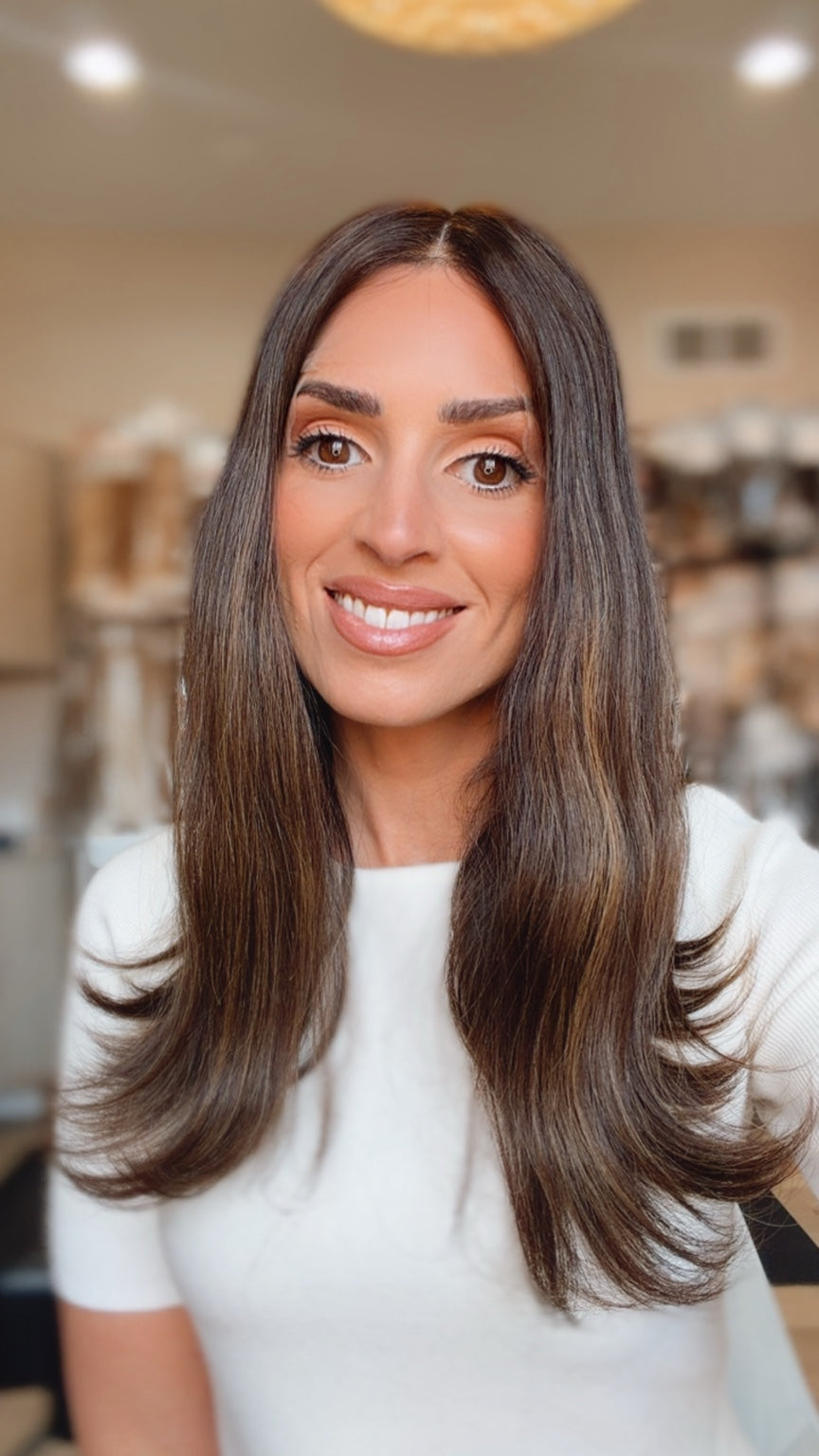Terese 18-inch dark brown wig with subtle peekaboo highlights worn on a model