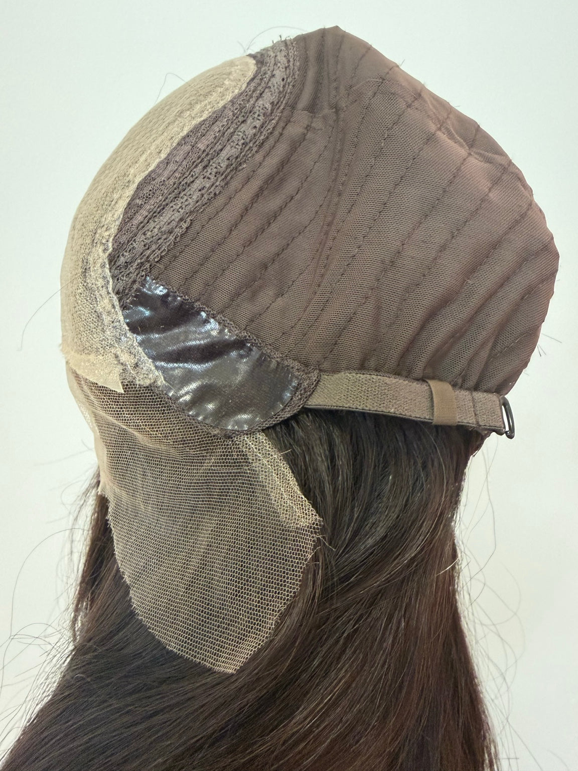 Terese dark brown wig with subtle peekaboo highlights, side cap